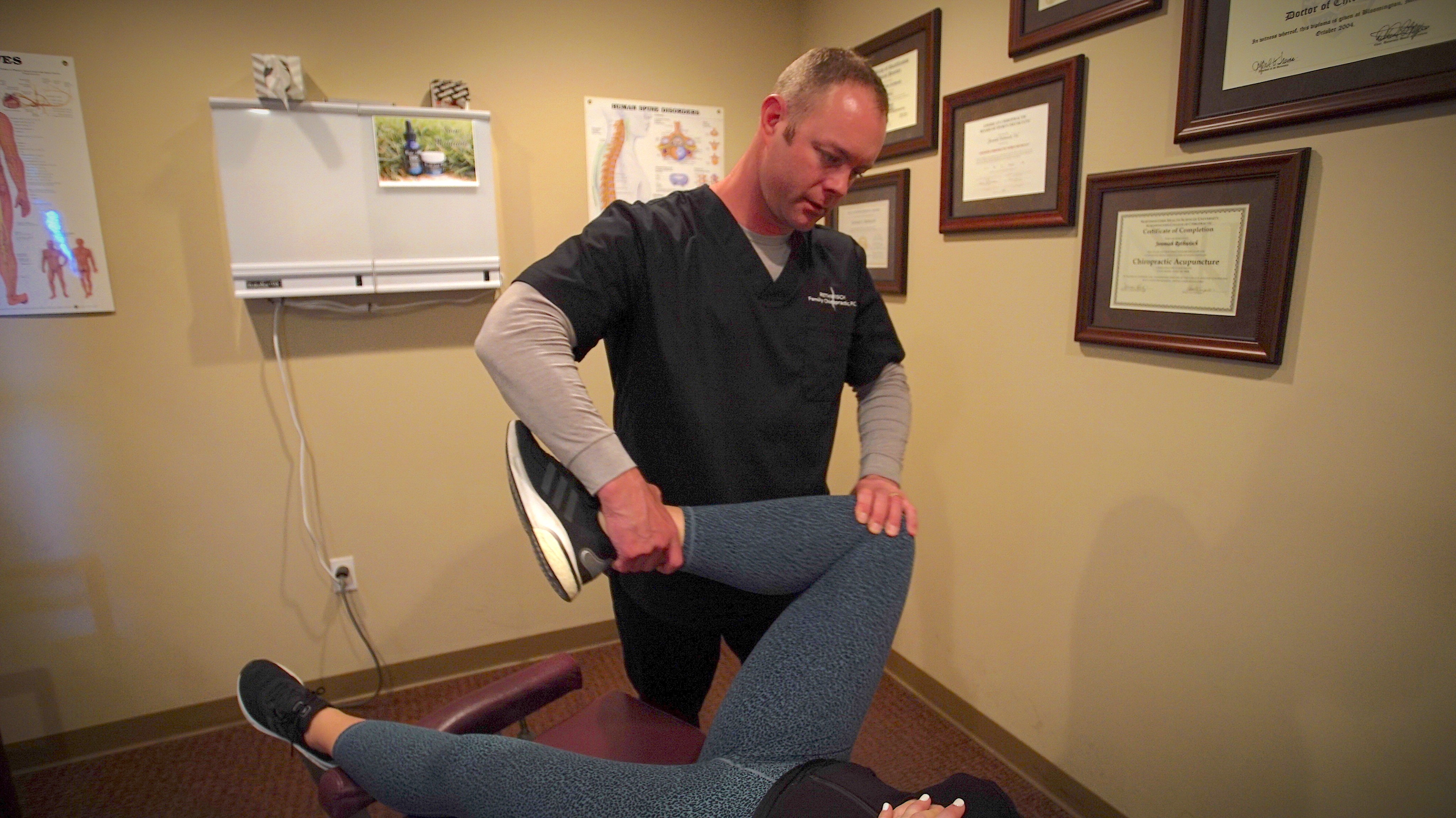 Doctor performing a hip assessment