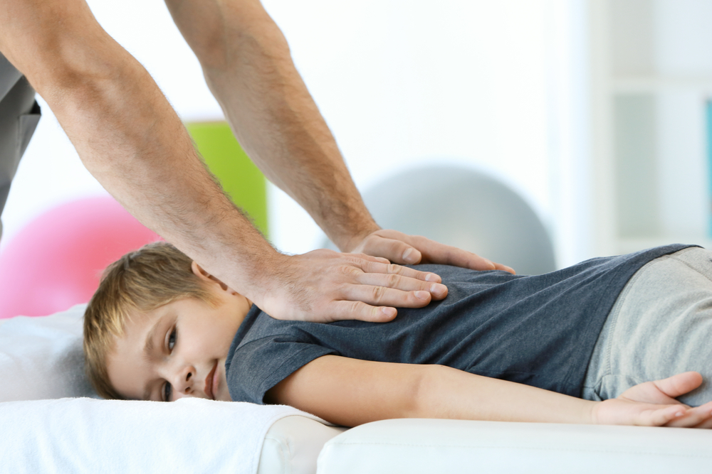 Child being adjusted by a chiropractor