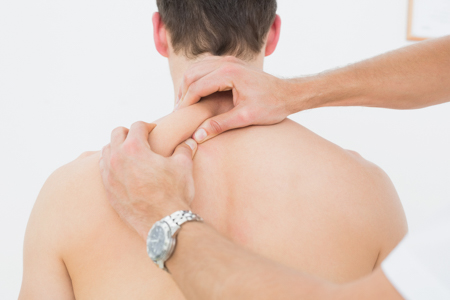 Physical Therapist performing muscle release techniques on a patient's shoulder