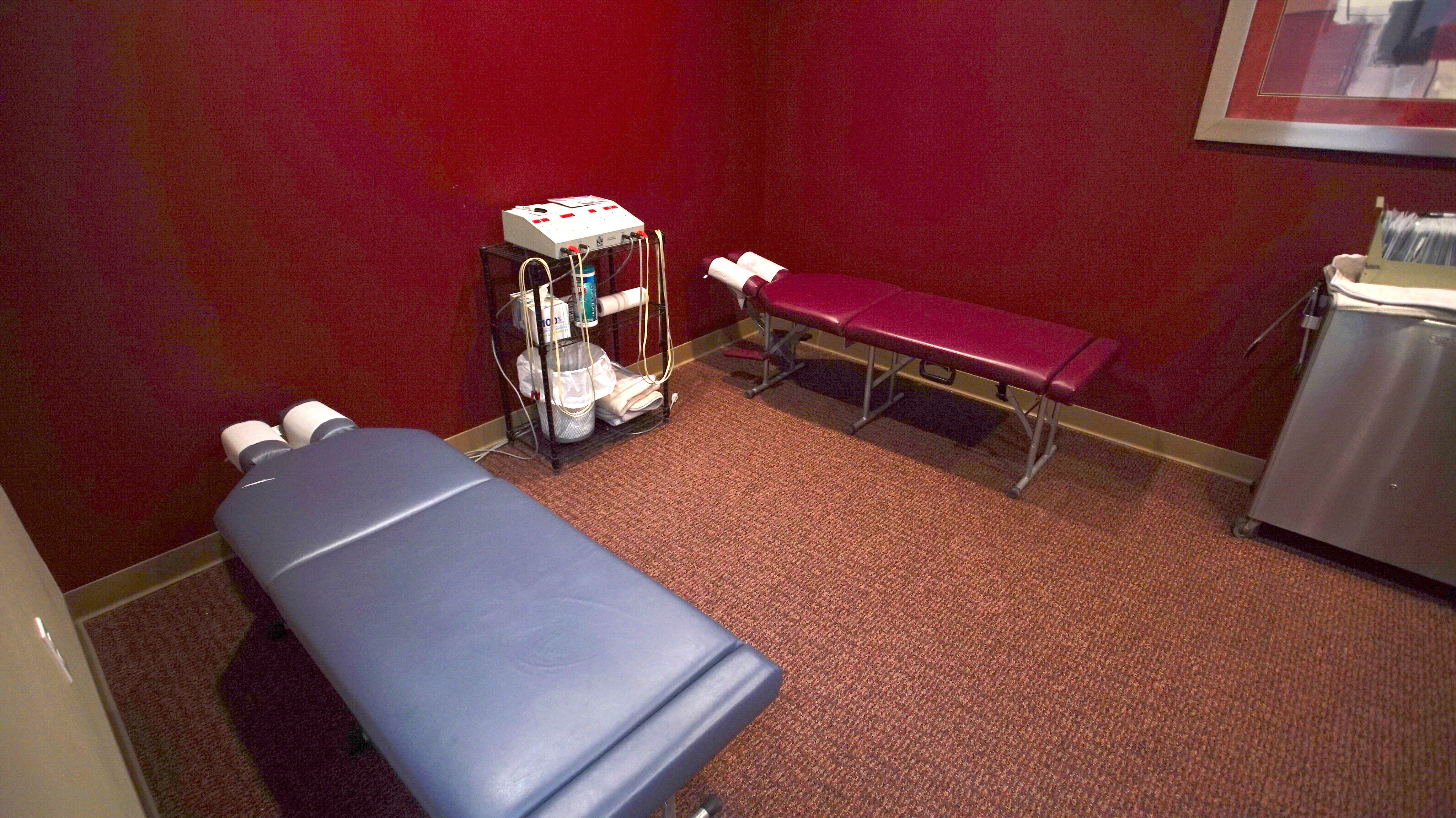 Therapy treatment room with tables and physical therapy machines
